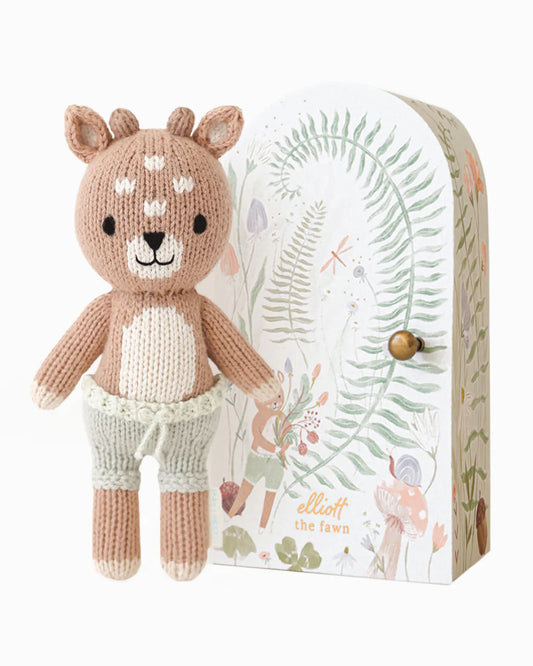 Knitted deer toy with a decorative box on a white background